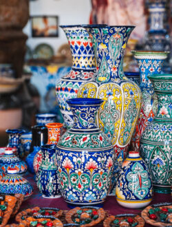 colorful traditional asian uzbek ceramic vases and jugs in oriental shop at pottery workshop in uzbekistan
